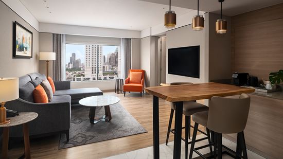 Living Room, Pantry & Cityscape View in Club Two Bedroom Corner Suite